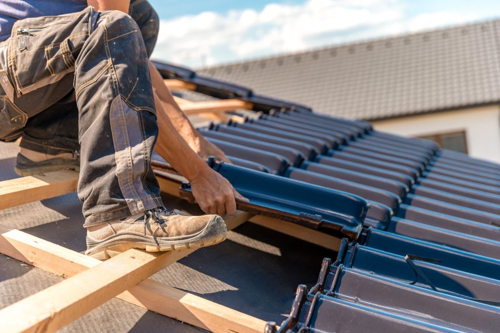 Contractor repairing roof