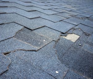 House with badly damaged shingles