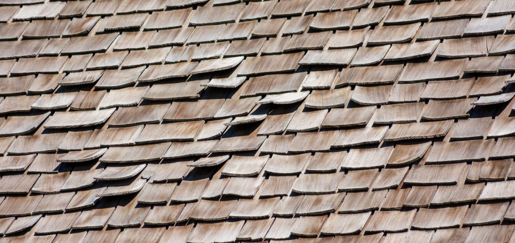 house roof shingles damaged and cracked due to sun and heat