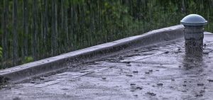 Flat roof with heavy rain pouring on