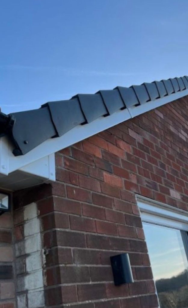 Grey dry verge units and white fascia boards fitted along a bungalow roof edge